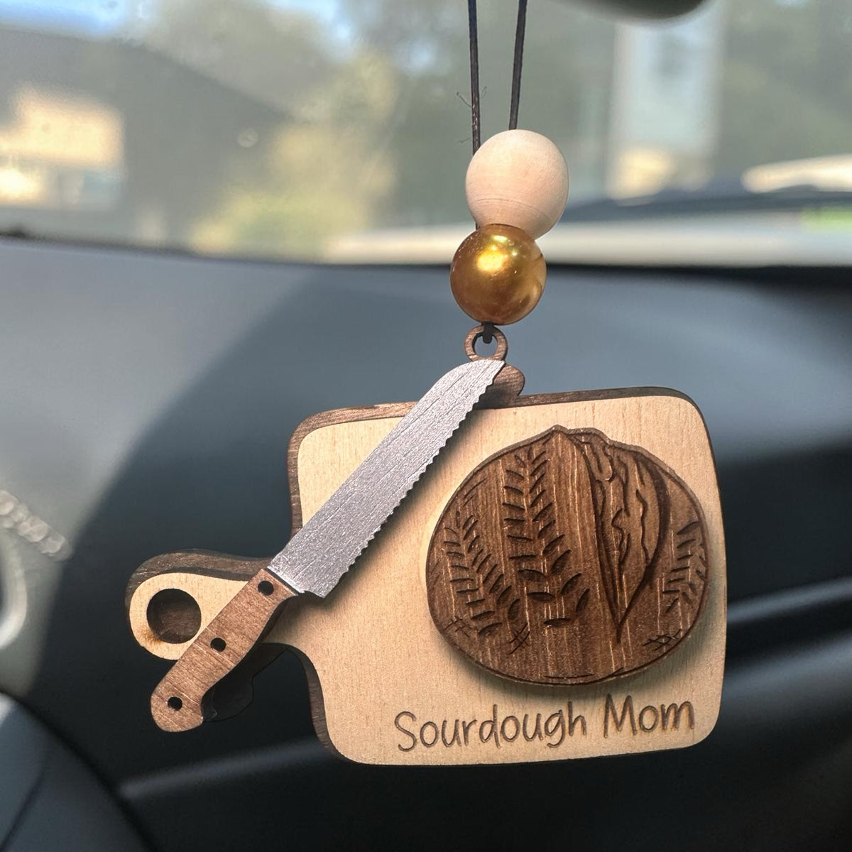 Squiggle Laser and Design wooden Sourdough Mom hanging ornament with bread, knife, and gold beads for car rearview